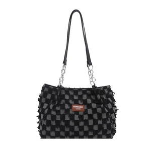 Denim checkerboard baguette bag with frayed edges and leather chain strap in black and grey