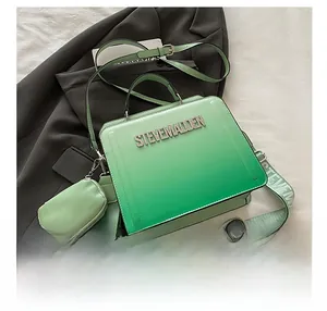Detail of gradient green crossbody bag with detachable round coin purse and logo strap