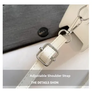 Detail of adjustable leather strap with polished silver metal buckle and rotating hook