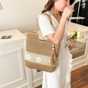 Woven straw tote bag with daisy embroidery and side fringe tassels for summer style
