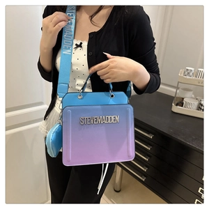 Detail of blue purple gradient tote with Steve Madden rhinestone logo and wide strap