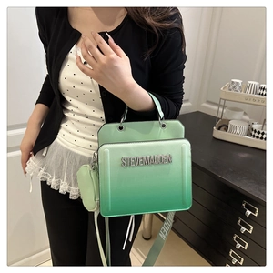 Detailed view of bright green gradient tote bag with rhinestone lettering on wide strap