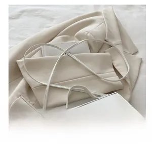 Detail showing the comfortable shoulder strap of this white minimalist leather satchel bag