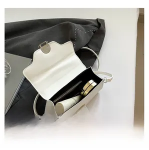 Interior view showing capacity of white leather flap shoulder bag with silver hardware