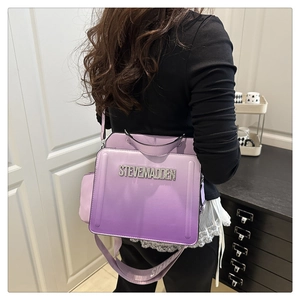 Detail of gradient purple crossbody bag with rhinestone logo and branded wide strap