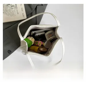 Top view showing spacious interior of white tote bag holding phone, umbrella and fan