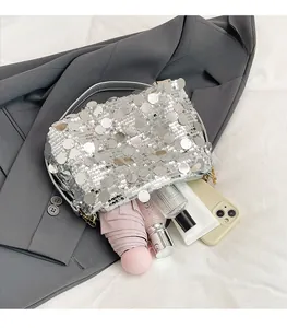 Top view showing spacious interior of silver sequin shoulder bag with daily essentials