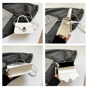 Detail view of white leather bag showing silver hardware, interior lining and side profile