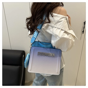 Detail of blue gradient crossbody bag with Steve Madden logo and matching strap
