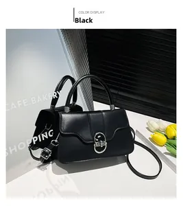 Detail view of the black retro shoulder bag featuring a silver metal rotary twist lock