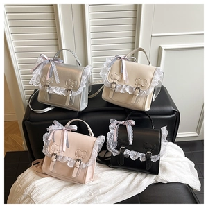 Detail showing lace trim and ribbon bows on multi-way PU leather crossbody bags