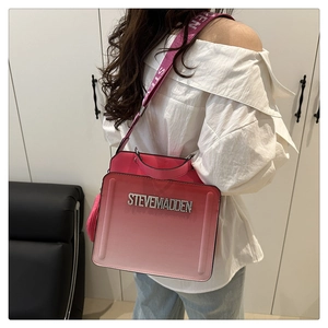 Pink gradient crossbody bag detail featuring Steve Madden metal logo and woven strap