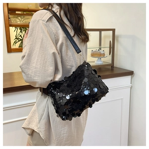 Close-up of a black sequin shoulder bag with layered round reflective textures for party style