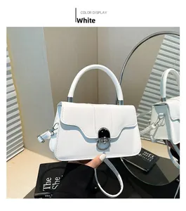 Detail of white leather shoulder bag with metallic lock closure and mirror reflection