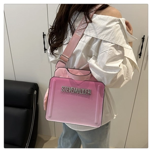 Detail of pink gradient handbag with rhinestone logo and adjustable textile shoulder strap