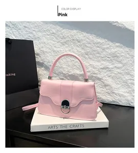 Detailed view of pink PU leather handbag with silver semicircular buckle and wavy flap design