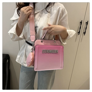 Macro detail of pink gradient crossbody bag with Steve Madden logo and heart pouch