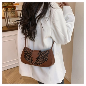 Trendy leopard print underarm bag featuring a unique brown lightning-shaped leather buckle.