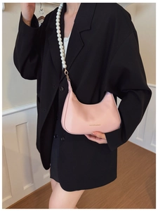 Fashionable pink crescent shoulder bag with white pearl chain and gold hardware detail