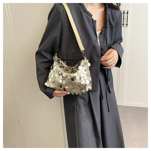 Detail of silver sequin shoulder bag with metallic fish-scale texture and slim strap