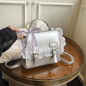 Silver metallic backpack with lace trim and pink plaid bow in a sweet preppy style