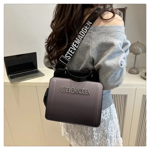 Close-up of Steve Madden crossbody bag with gradient finish and rhinestone logo