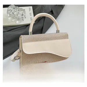 Detailed close-up of champagne gold sequined handbag with unique wave curved flap