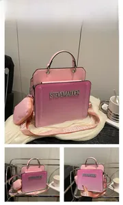 Detail of light pink gradient handbag with rhinestone logo and heart-shaped coin purse