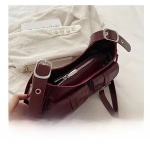 Dettaglio della borsa tote vintage rosso scuro con tasche con fibbia e cerniera scorrevole