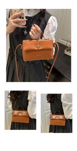 Brown Kelly bag with houndstooth textured panel and gold rotating metal buckle detail