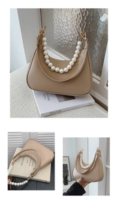 Detail of beige half-moon bag featuring large pearl handle and FASHION & BAGS logo