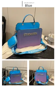 Detail view of the Steve Madden blue-purple gradient handbag with rhinestone logo