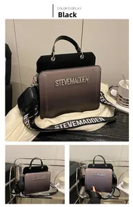 Detail of gradient leather handbag with metal logo and patterned woven shoulder strap