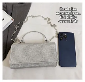 Silver glitter evening clutch size comparison with smartphone and chain strap detail