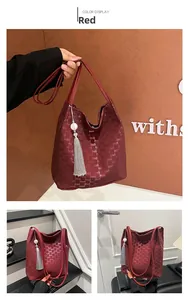 Multiple views of red plaid bucket bag with logo pattern and tassel accessory