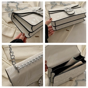 Detail view showing marble texture, rhinestone buckle, and interior of the white square bag