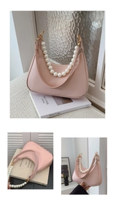 Detail of pink half-moon saddle bag with pearl chain handle and leather strap
