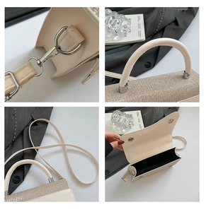 Close-up of champagne gold panel and silver hardware on cream crossbody bag