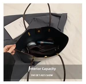 Detailed interior view showing large capacity and zipper compartment of brown tote bag
