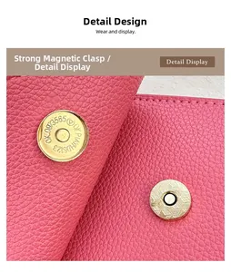 Detail of pink lychee leather handbag featuring a strong golden magnetic snap closure
