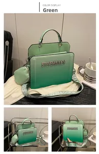 Detail of green gradient tote bag featuring rhinestone logo and wide fabric strap