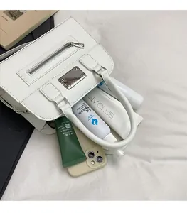Close-up showing the spacious interior capacity of this white leather commuter tote bag