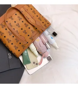 Detailed interior of a brown tote bag showing large capacity for essentials