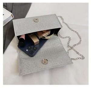 Interior view of silver rhinestone evening clutch bag showing spacious capacity for makeup