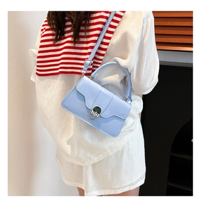 Pale blue faux leather crossbody bag styled with a white shirt and striped scarf