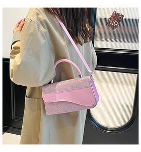 Detail of pink sequin patchwork handbag with a unique saddle-style flap and shoulder strap