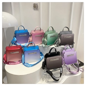 Detail of colorful crossbody bags with wide logo straps and matching round coin pouches
