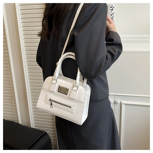 Detail view of a white Boston shoulder bag featuring metallic accents and dual handles