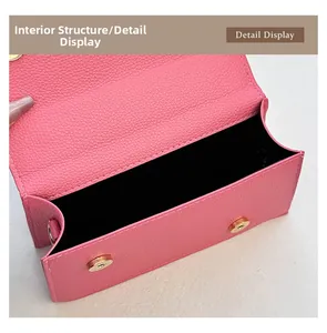 Detailed view of pink pebble leather bag interior with black lining and gold magnetic snaps
