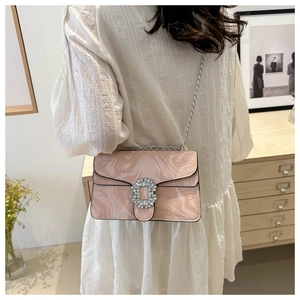 Detail showing pink marble texture chain bag with a diamond buckle on a female model